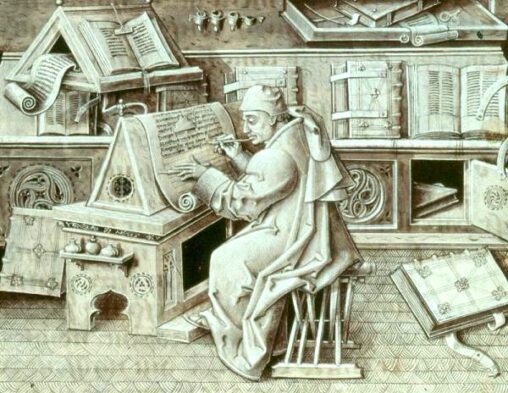 The image depicts a medieval scribe seated at a writing desk. He is dressed in traditional attire, including a hat and robe, and is meticulously copying text from a large book using a quill pen. Surrounding the scribe are various books and manuscripts, some of which are open on stands, while others are bound and stacked on shelves. The workspace is richly detailed with ornate carvings and intricate designs, reflecting the scholarly environment of the period.